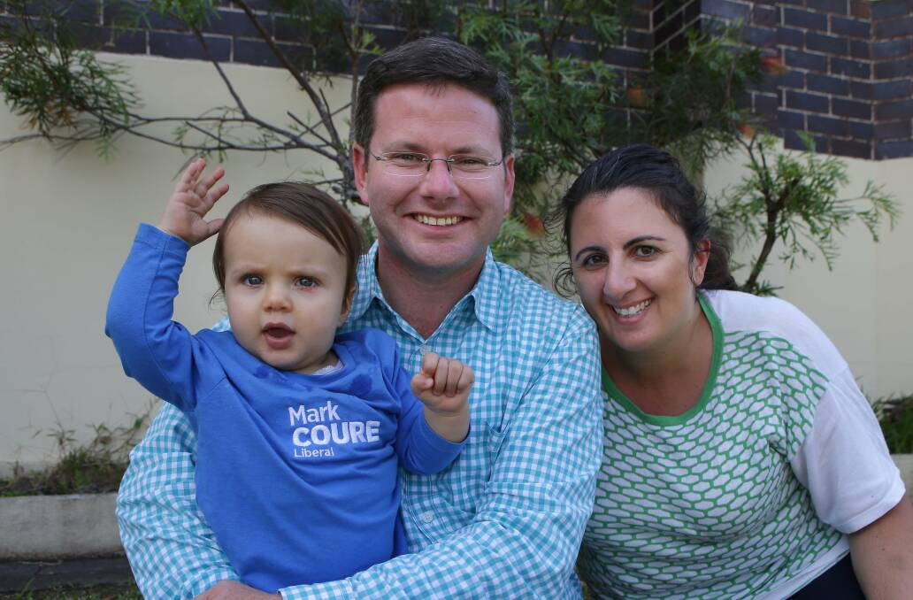 Winners are grinners: Mark Coure with wife Adla and son James who just turned 1. Picture John Veage