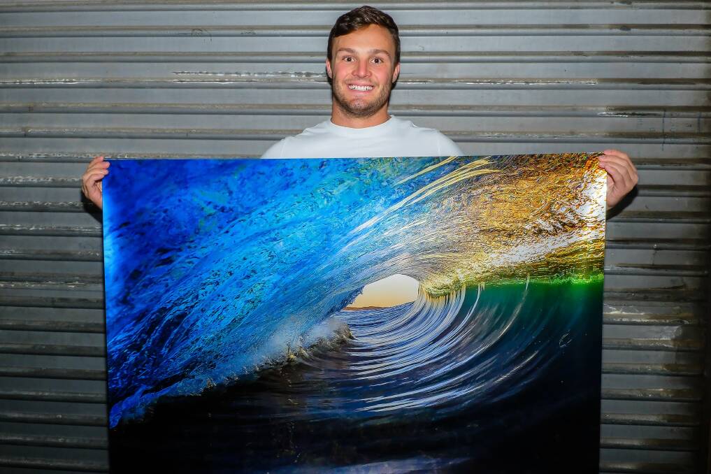 On right wavelength: Chris Dixon with Halcyon, a metallic print of an empty wave. Picture: Chris Dixon