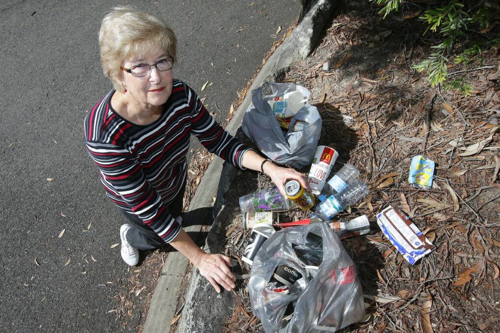 A disgrace: Mrs Carol Reynolds is angry that people are littering at the on and off ramps at Illawong.Picture John Veage