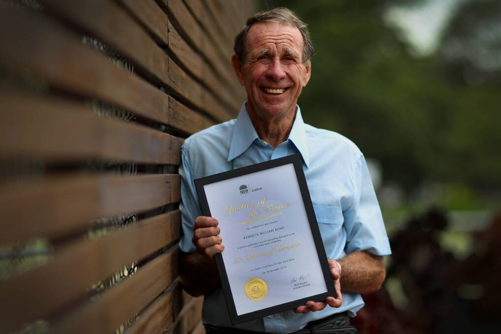 His word is his bond: Ken Bond with his certificate for 50 years as a JP. Picture: Simon Bennett
