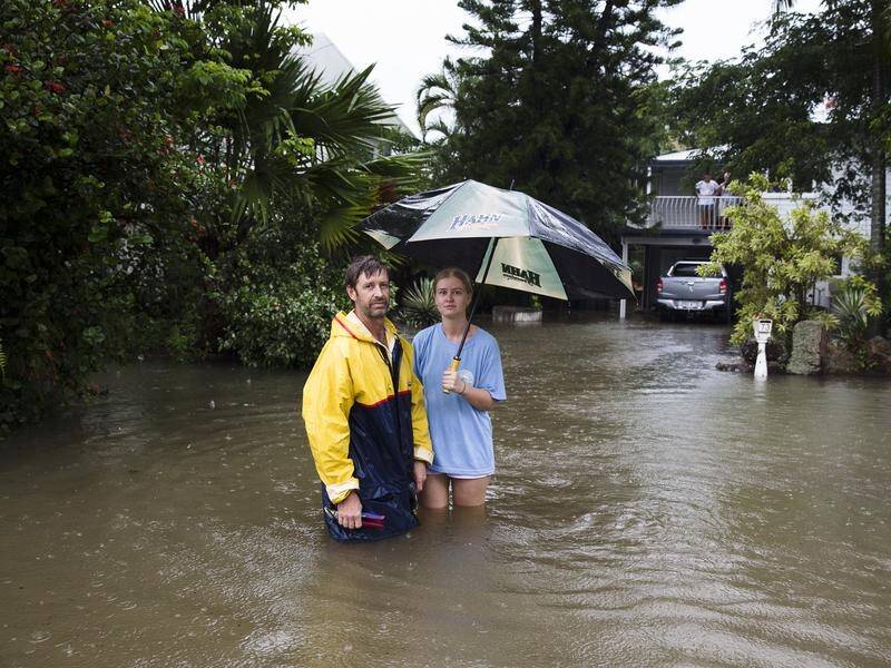 Paul Shafer and daughter Lily watched the floodwaters rising under their Townsville home.