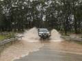 Flooded roads have made driving conditions hazardous such as in Vineyard, near Sydney. (Flavio Brancaleone/AAP PHOTOS)