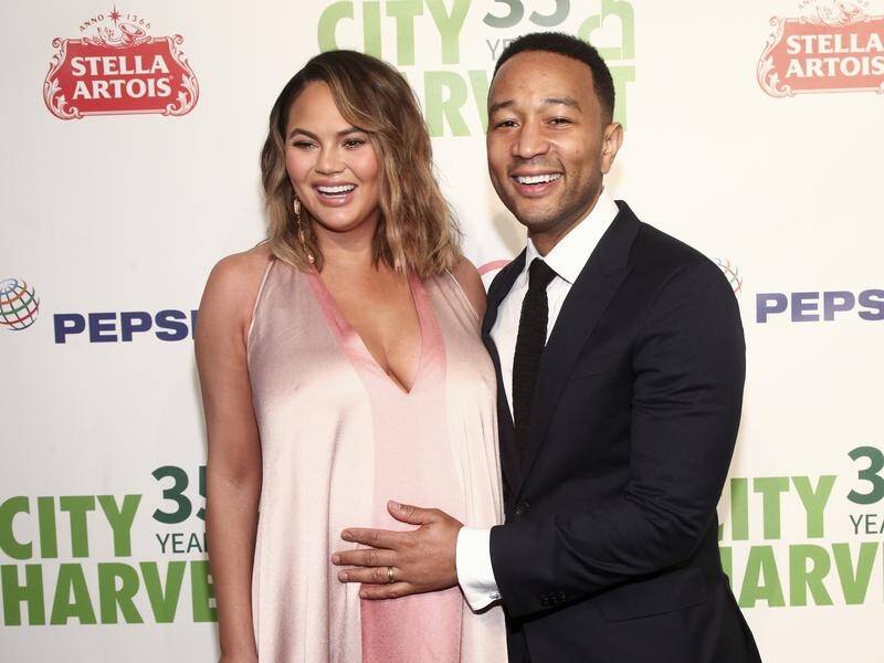 Chrissy Teigen (L) says a man took a topless picture of her while she was pumping breast milk.