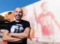 Indigenous performer Ben Graetz appears in the Darwin mural with his husband. (Charlie Bliss/AAP PHOTOS)