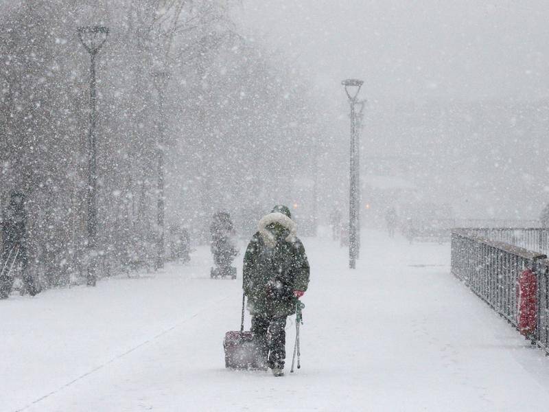 The UK has been hit by heavy snow and strong winds after a severe cold spell.