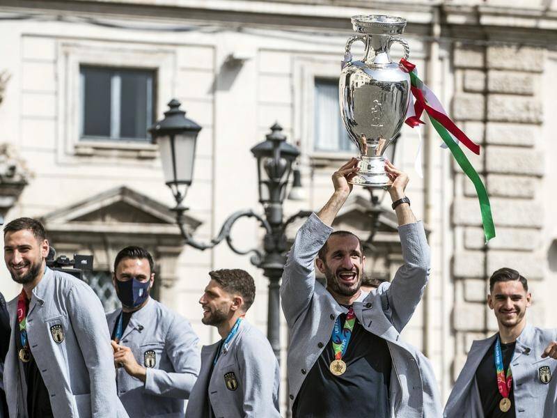 Italian captain Giorgio Chiellini lifts the European Championship trophy in Rome.