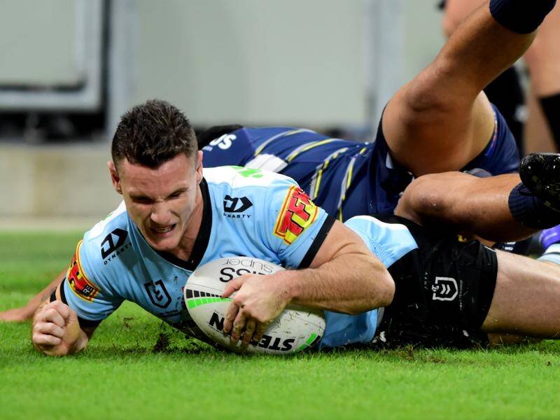 Connor Tracey scores a try for Cronulla who held off North Queensland to enter the NRL top eight.