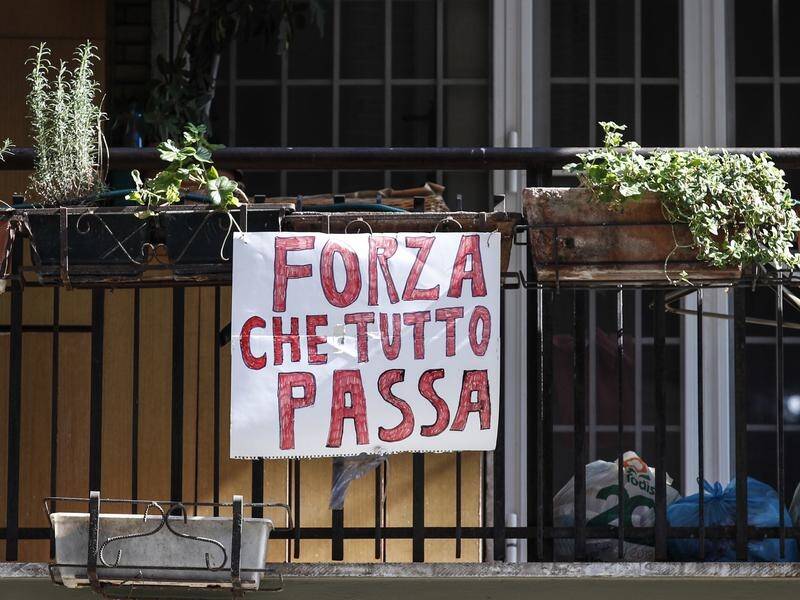 Everything will pass, a banner says on a balcony in Rome amid Italy's coronavirus lockdown.