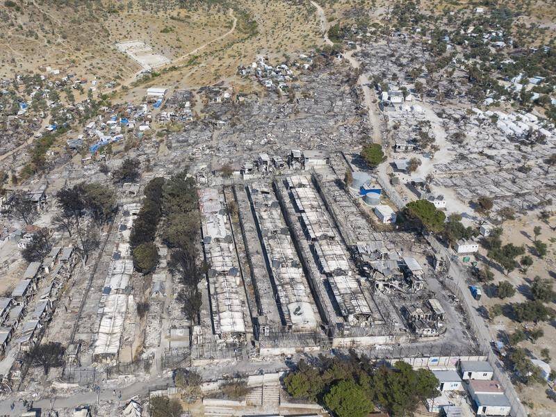 Five migrants have been detained by Greek police after a fire destroyed the Moria refugee camp.
