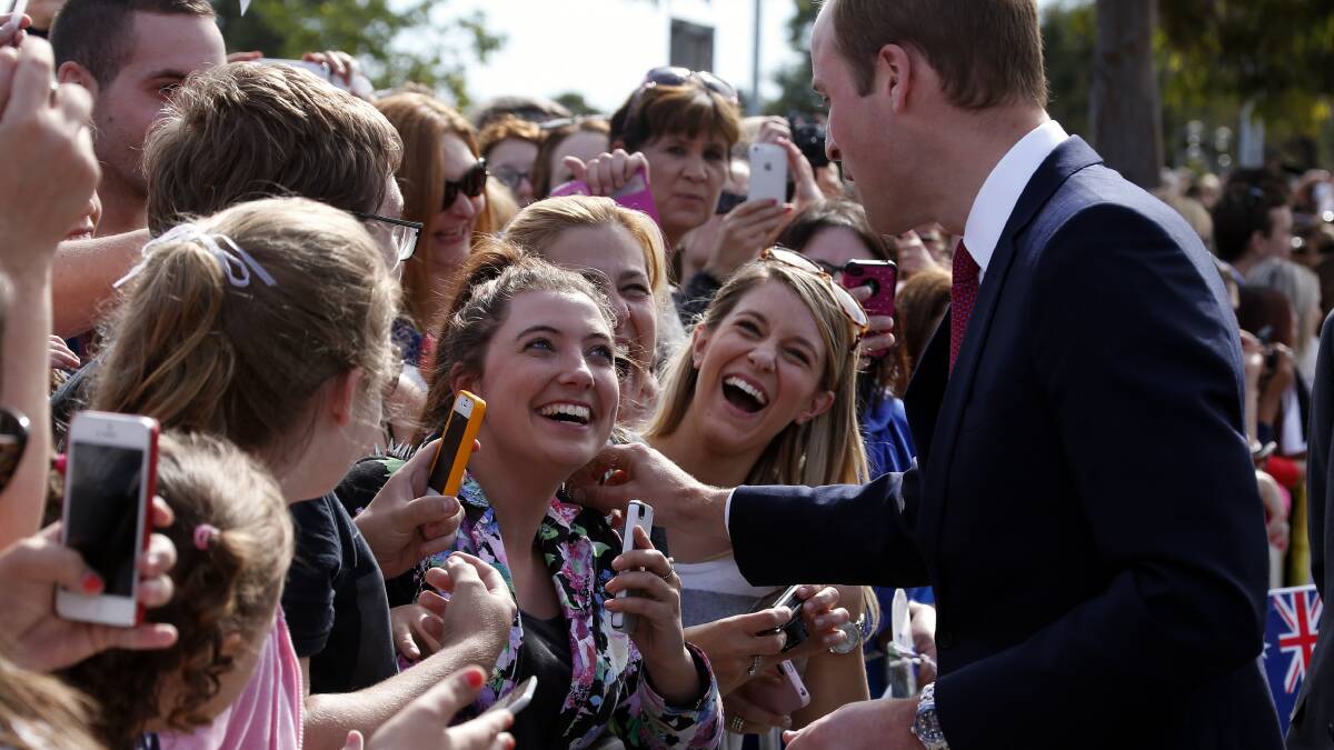 Prince William, Duke of Cambridge touches a woman's jacket as he greets members of the crowd with his wife Catherine, Duchess of Cambridge, at the Playford Civic Centre in the Adelaide suburb of Elizabeth on April 23. Picture: Getty Images.