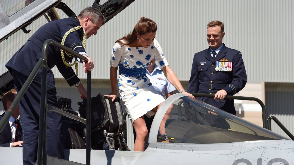 Flanked by Chief of Air Force, Air Marshall Geoff Brown, and Commanding Officer of Number 1 Squadron , Wing Commander Stephen Chappell, Catherine, the Duchess of Cambridge, makes her way into the cockpit of a RAAF Super Hornet of 1 Squadron at the Royal Australian Airforce Base at Amberley on April 19. Picture: Getty Images.