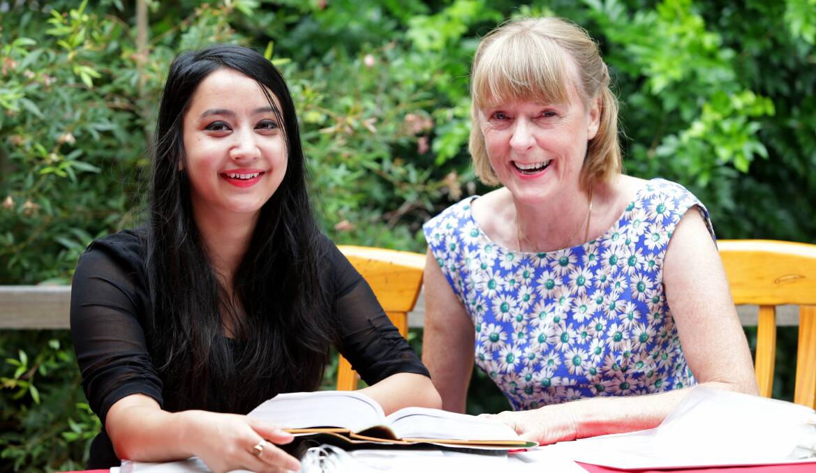 Educational support: University volunteer Denise Costello helps migrant students from non-English-speaking backgrounds, such as Tamuja Khadka from Nepal, develop their English skills. Picture: Jane Dyson

