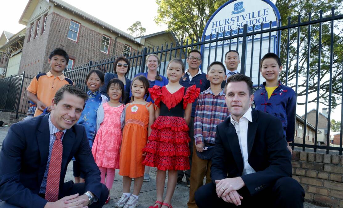 Classroom promise: Ryan Park (left) and Chris Minns and with pupils and parents at Hurstville Public School. Picture: Jane Dyson
