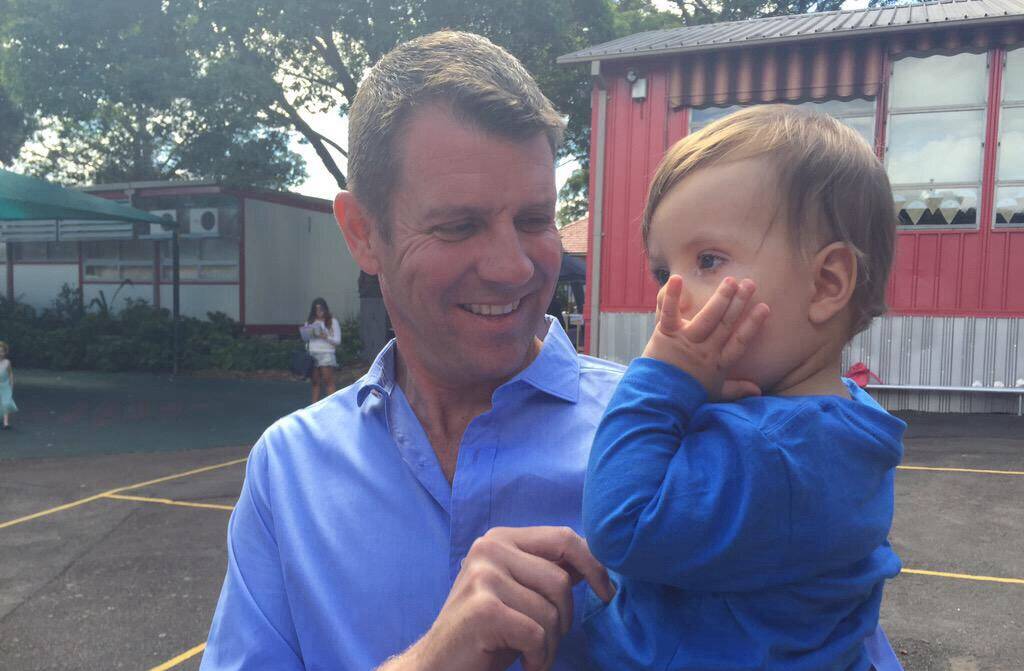 Happy Birthday: Premier Mike Baird at a polling booth for Oatley electorate  holding Mr Coure's son James. Picture: Sarah Gerathy, Twitter.