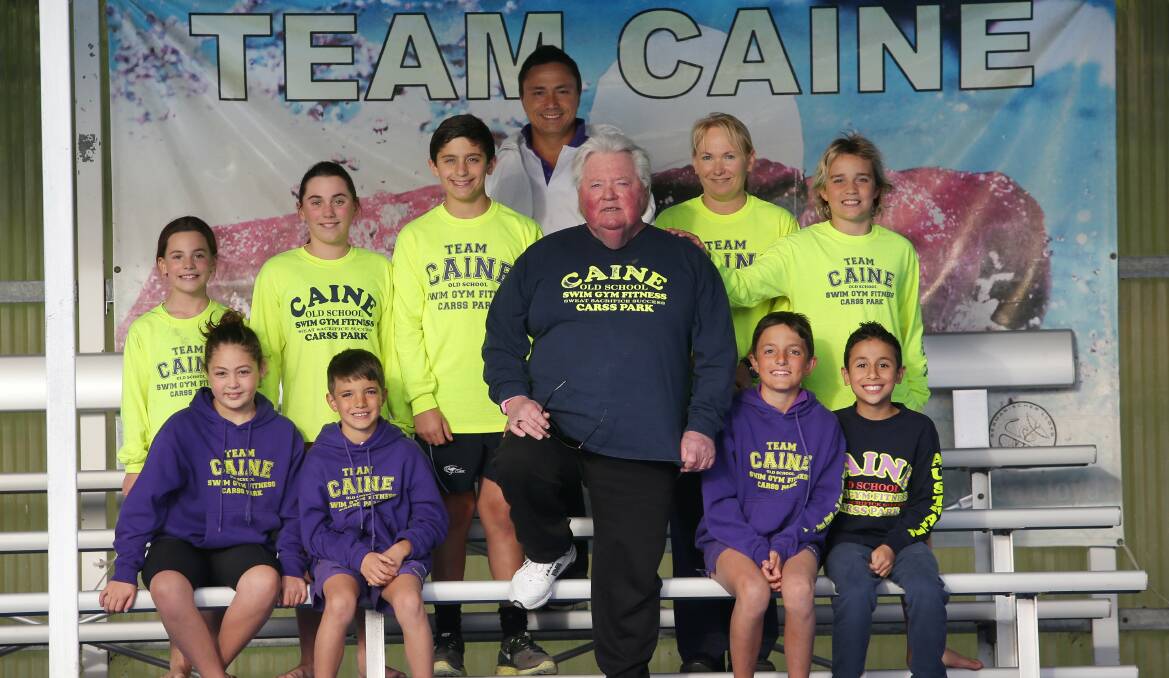 ‘‘Like family’’: Dick Caine and squad members at Carss Park War Memorial Olympic Pool. Back row (from left): Indiana Field, Talia Field, Jayden Maakaroun, Troy Tam, Danielle Field, Ethan Payne. Front (from left): Zeinab Kassem, Liam Athanassiou, Dick Caine, Evan Athanassiou, Adam Tehfe. Picture: John Veage
