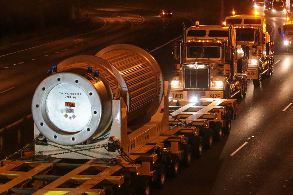 Long haul: The 1km-long convoy makes its way to Lucas Heights. Inset, The BBC Shanghai, with its cargo of nuclear waste, arrives at Port Kembla. Main picture: Adam McLean
