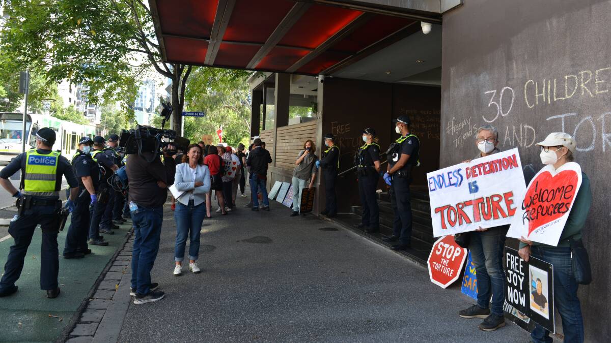 Protesters gather outside the hotel where Novak Djokovic was detained while in Melbourne. Picture: Getty Images