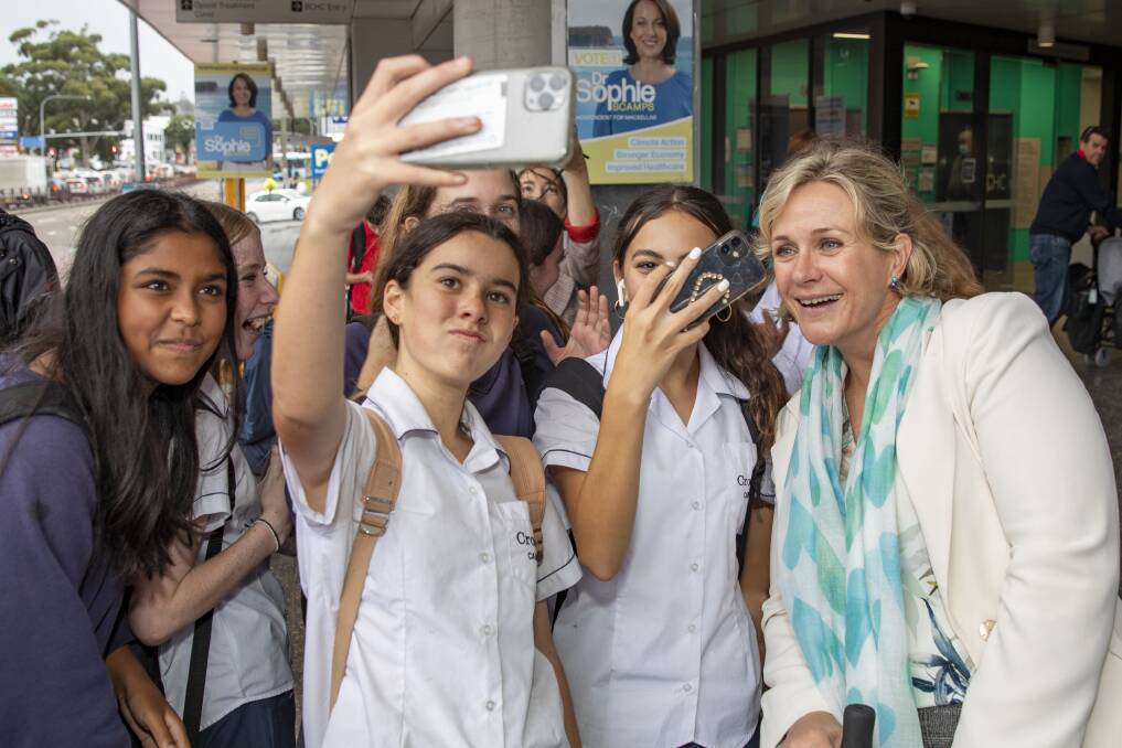 FANS: Incumbent independent MP for Warringah, Zali Steggall, with some excited school students outside the pre-poll voting in Brookvale. Picture: Dallas KIlponen