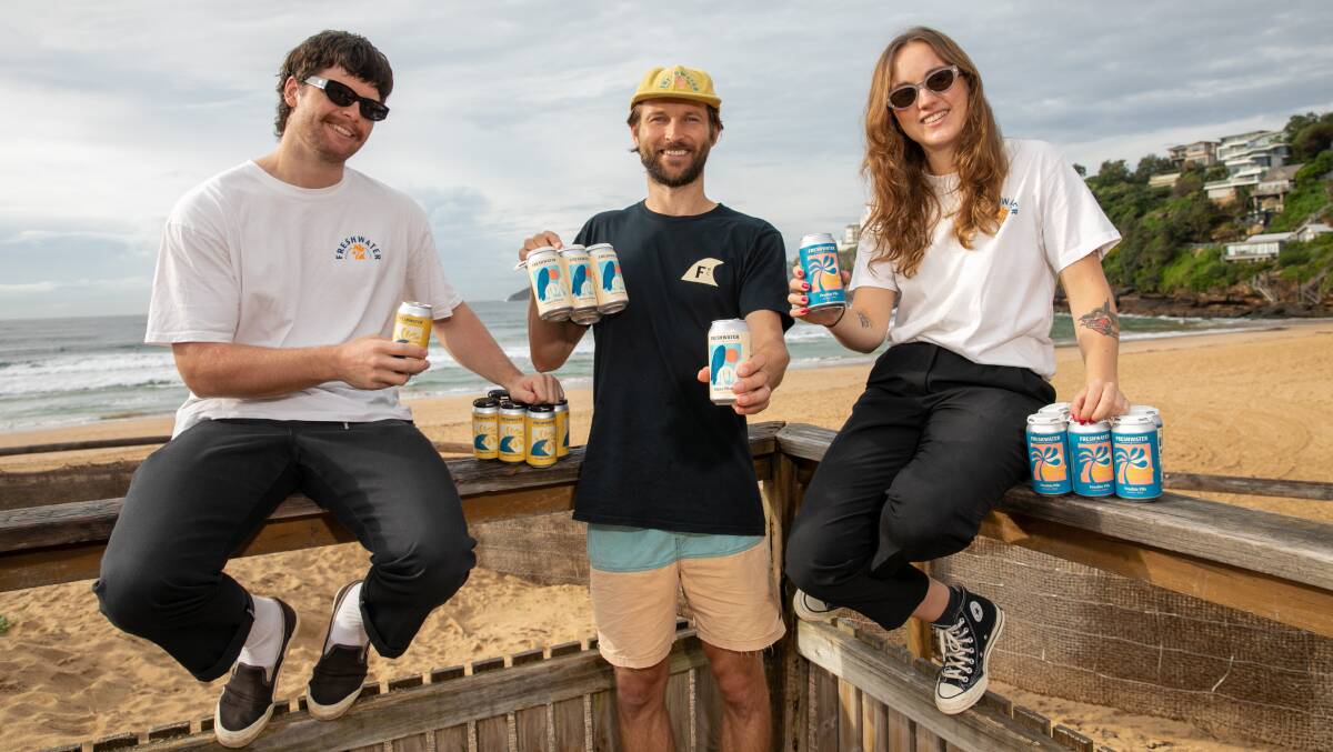 HERE'S CHEERS: Freshwater Brewing Company's Tom Bruce, Brett Phillips and Chloe Morgan-Webster showcasing their product at Freshwater Beach. Picture: Geoff Jones