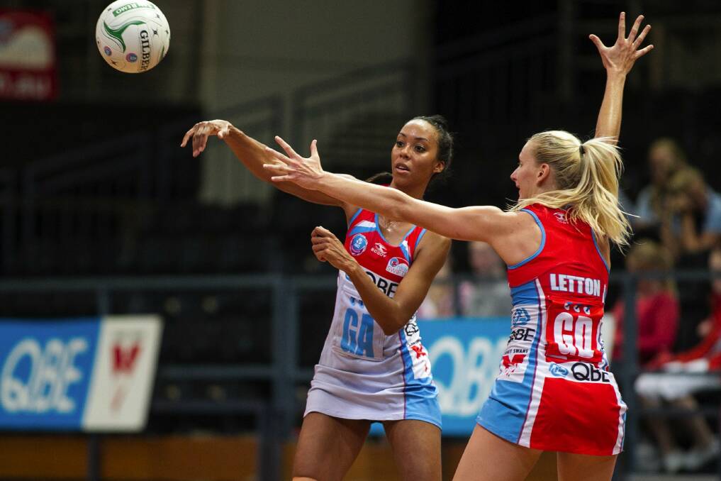 Competitive: Carla Dziwoki passes over April Letton at the NSW Swifts Fan Day. Picture: SMP Images