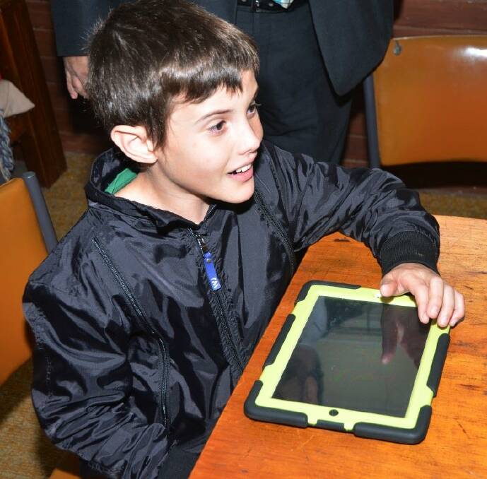 Tech assist: Ethan, 12, will benefit from a program aimed at helping children who are non-verbal.