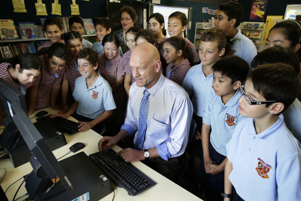 Who's smarter: Schools Minister Peter Garrett takes the challenge against year 6 pupil Tabby Juncal. Picture: Anna Warr