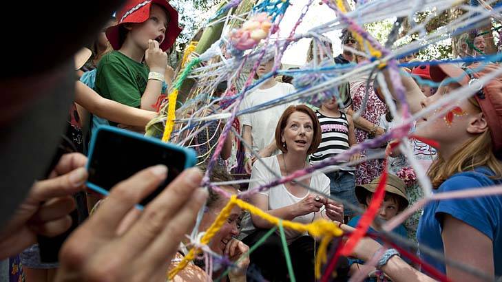 Peace, love and anything goes ... Julia Gillard, in the children's precinct, became the first sitting prime minister to visit the Woodford Folk Festival on Sunday.