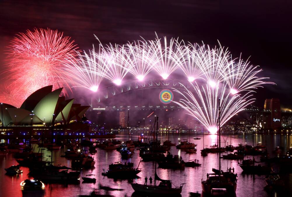 Bring in the new year with a bang:  Fireworks explode over Sydney Harbour Bridge and Sydney Opera House as more than a million people on the foreshores welcomed 2012. This picture was taken from Mrs Macquarie’s Chair, Sydney Royal Botanical Gardens. Picture: Janie Barrett