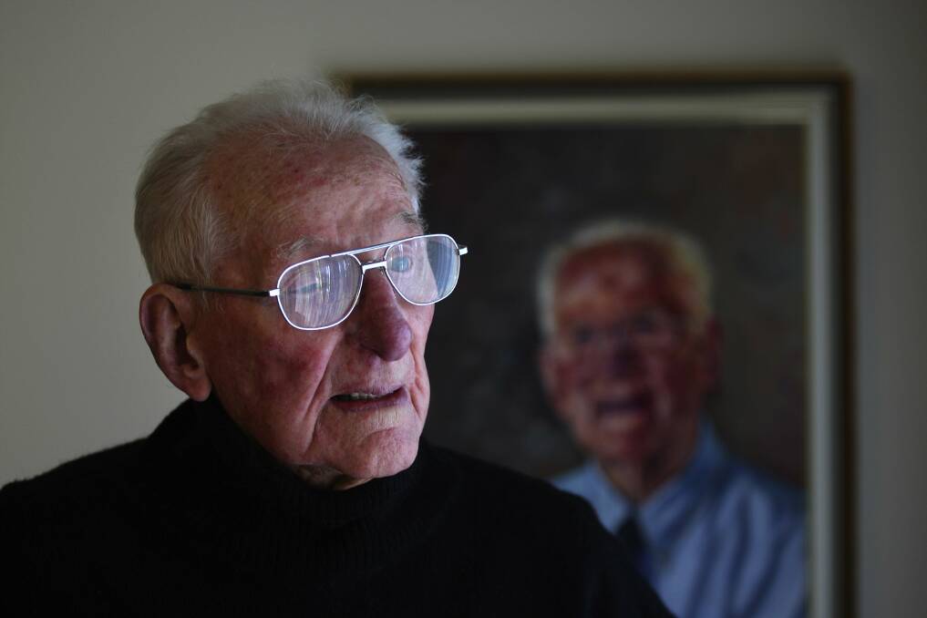 Just 97 years young: Bob Rowles, who retired after a record 67 years as supervisor of all Sydney race track jockeys, in front of his portrait which was nominated for the Archibald Prize. PIcture; John Veage