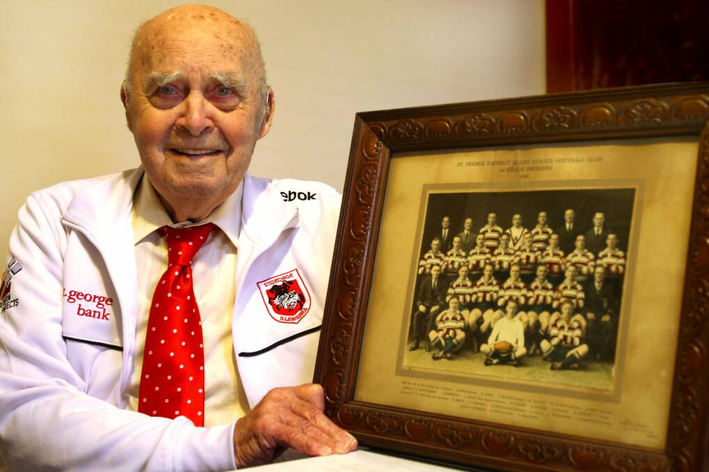The old team: Bill Collier with the photo of the 1941 St George premiership-winning side, at his Kingsgrove home.  Picture: Lisa McMahon