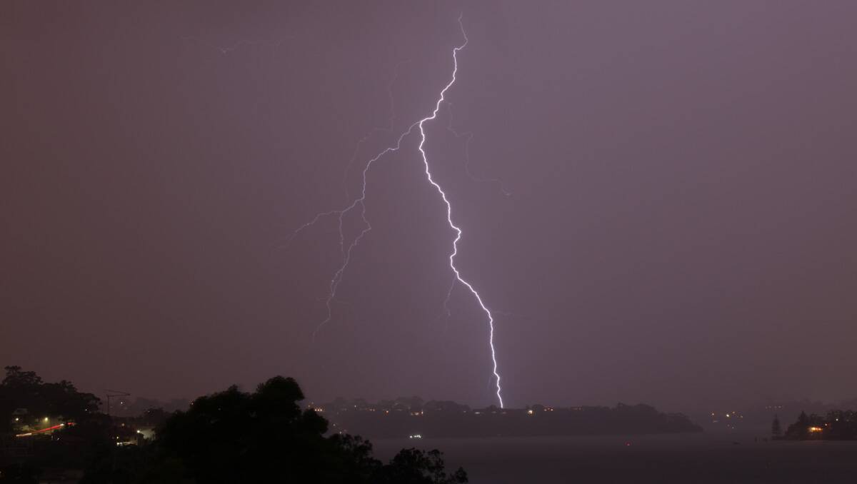 Lightning strikes: Reader Paul Hogan sent in this photo he took from Connells Point looking east across Kyle Bay to Baldface at Blakehurst on Friday night.