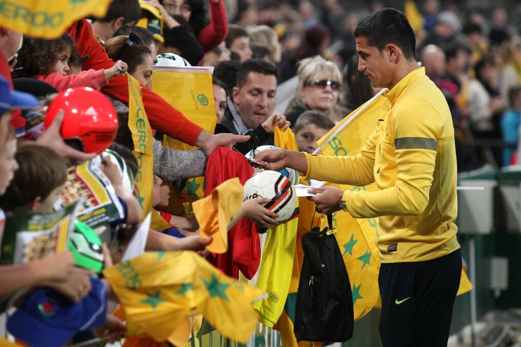 Socceroo Tim Cahill signs autographs for fans at Kogarah Oval before a training session. Picture: Jane Dyson