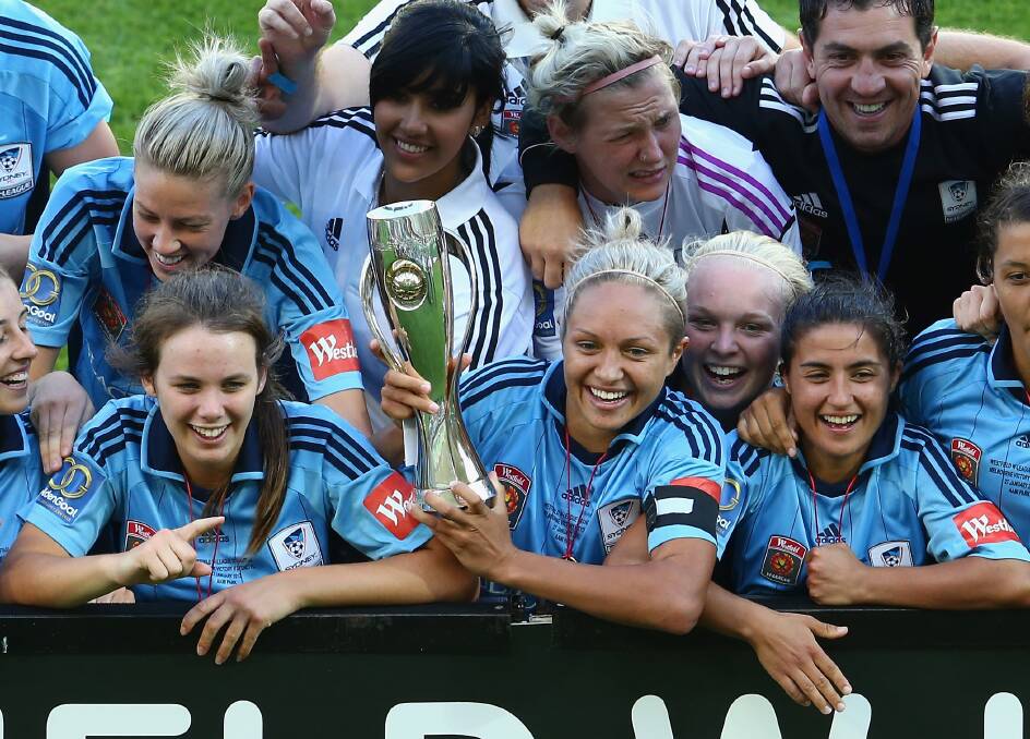 Champions: Teresa Polias (second from right, foreground) and team celebrate their W-League victory last year.  Picture: Robert Cianflone, Getty Images