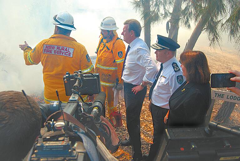 NSW Premier Barry O’Farrell, Rural Fire Service Commissioner Shane Fitzsimmons and Blue Mountains MP Roza Sage receive an update on the unfolding bushfire emergency in Winmalee on Wednesday, September 11, near a backburning operation on Leslie Road. 