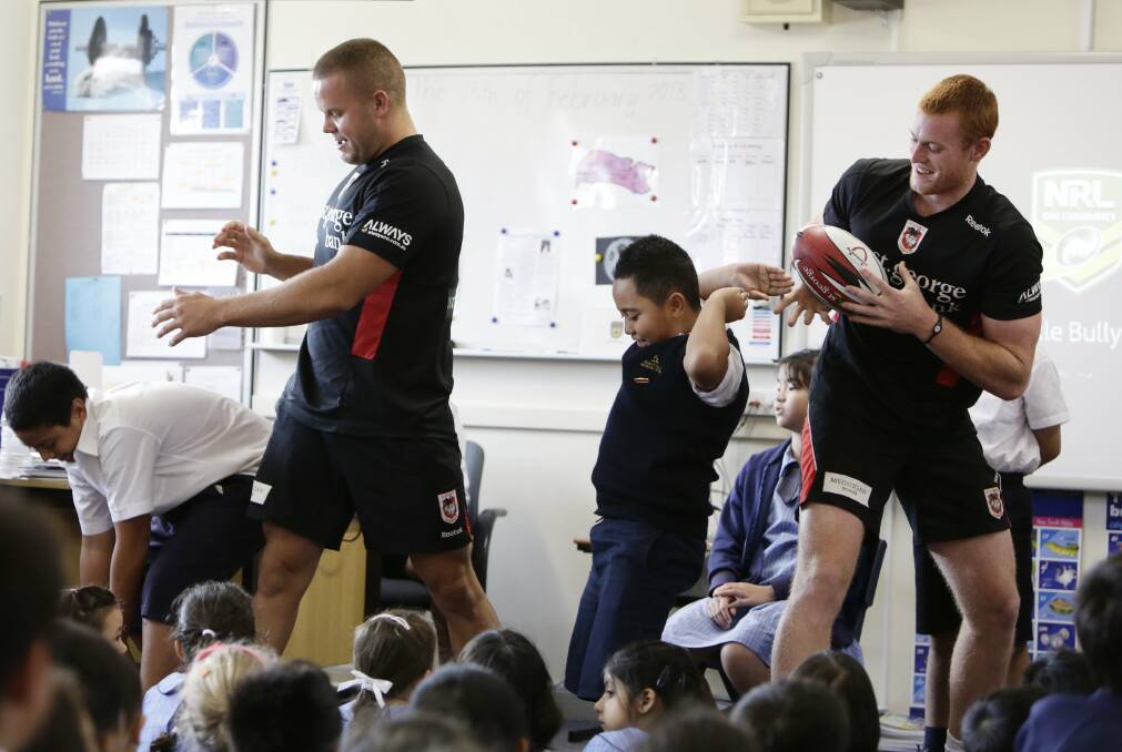 Interaction: Dragons players Dan Hunt (left) and Nathan Green spread an anti-bullying message to pupils at Hurstville Adventist School yesterday. Picture: Anna Warr